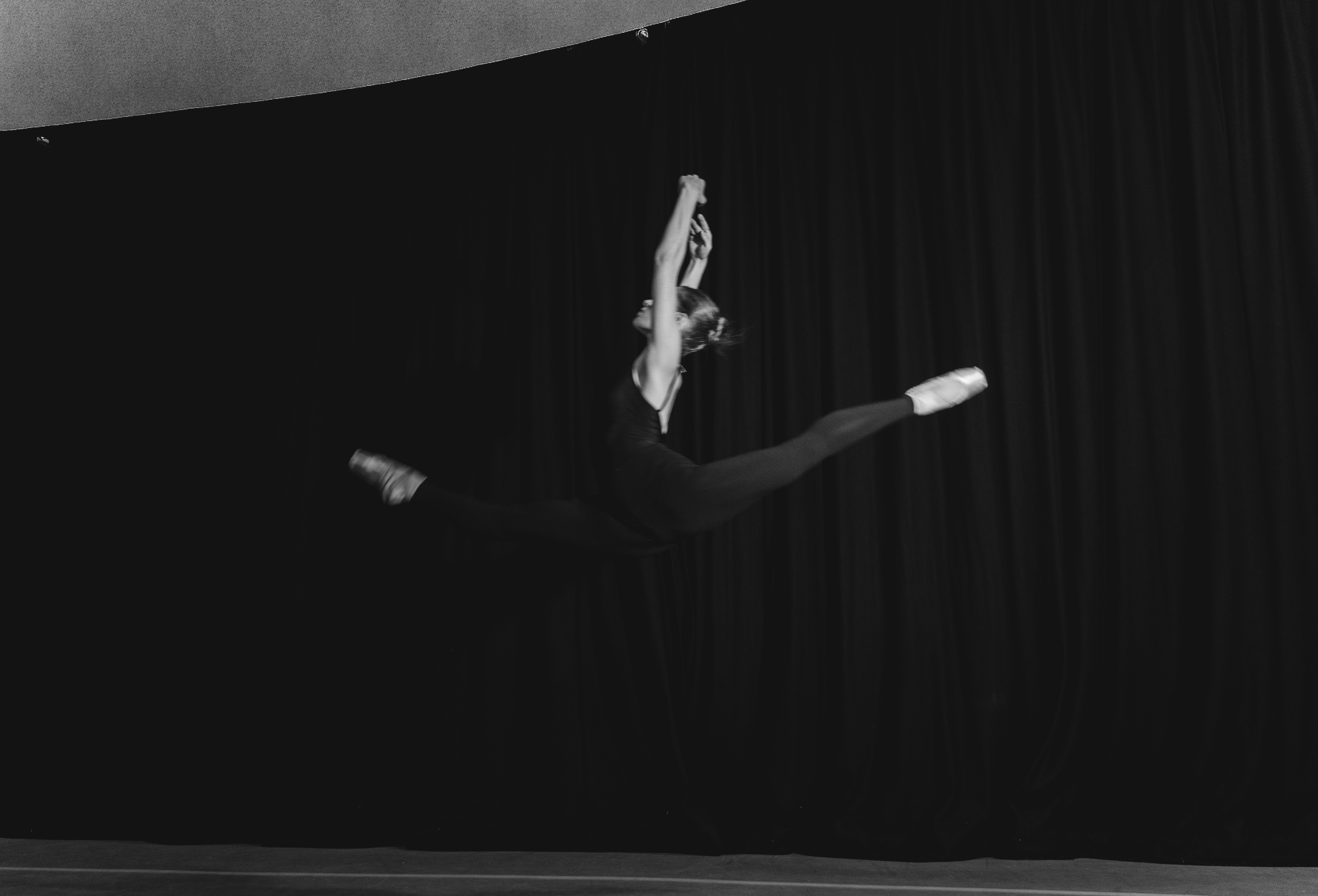 Hannah in a studio leap in black and white