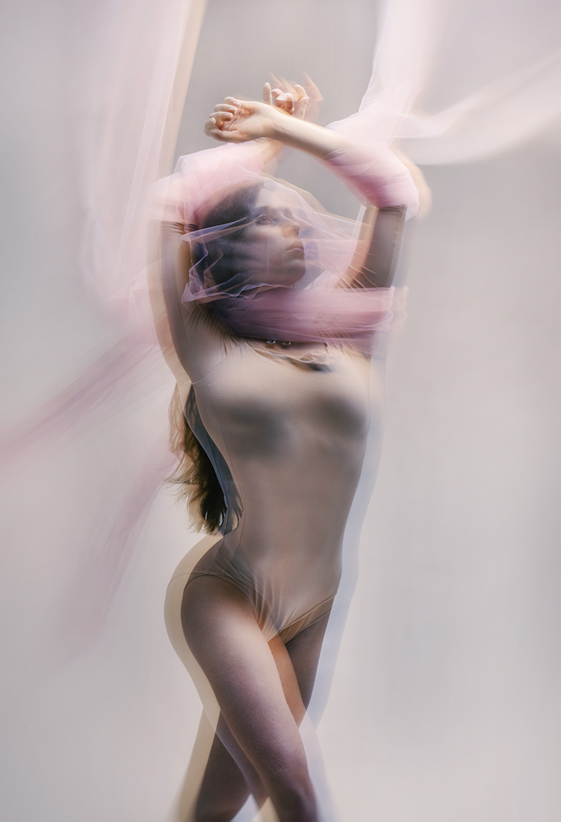 Hannah moving through translucent pink fabric